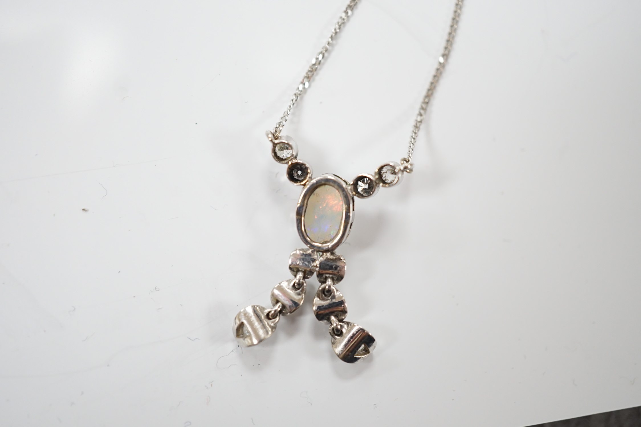 A modern 18ct white gold, white opal and diamond cluster set double drop pendant necklace, overall 56cm, gross weight 4.1 grams.